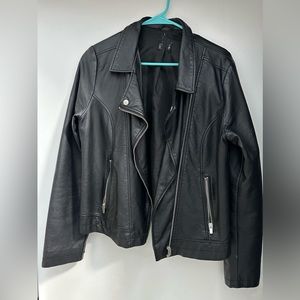 Faux leather. Tag is cut out but otherwise in good condition.